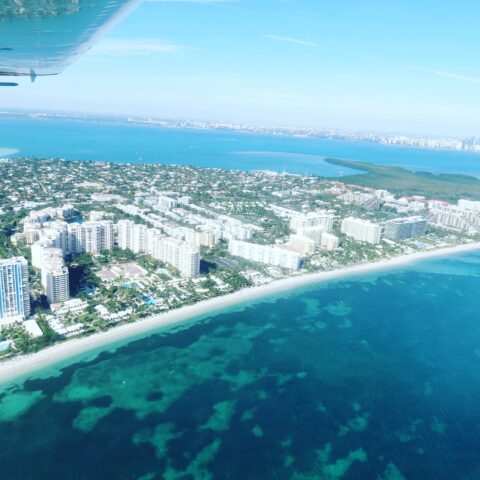 Aerial view of Miami Beach and crystal-clear water from Magic Air Tours airplane tour