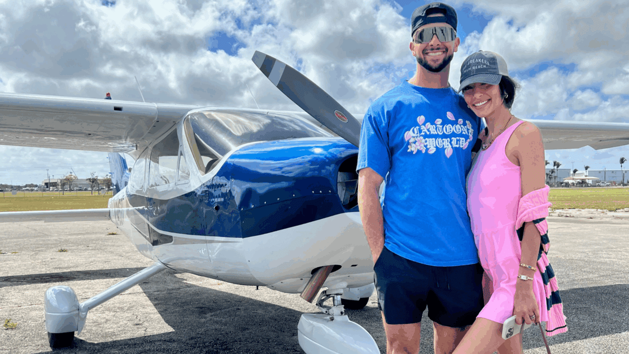 Couple in front of Magic Air Tours' brand new airplane ready for an unforgettable flight over South Beach and Miami’s iconic landmarks.