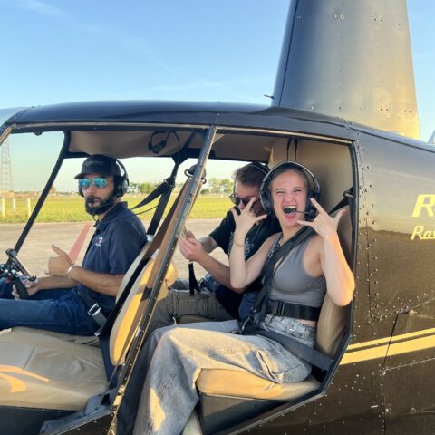 Girl enjoying doors-off helicopter ride over Miami coastline