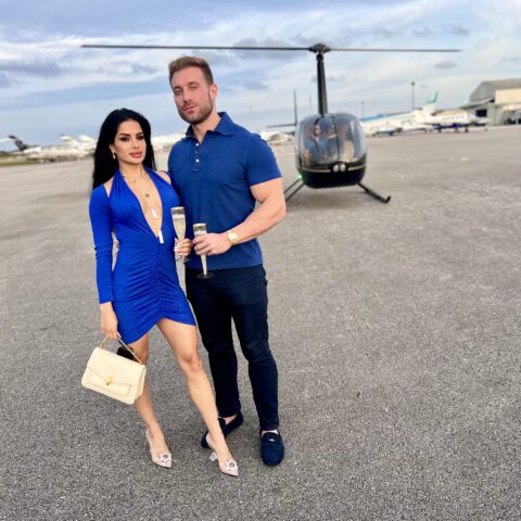Couple enjoying a romantic helicopter ride in Miami with champagne by Magic Air Tours