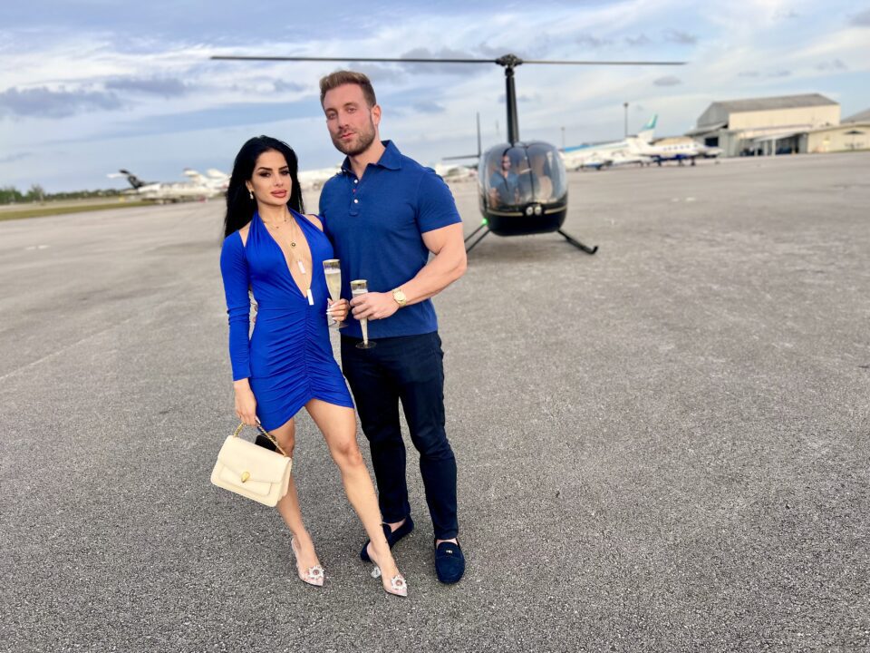 Couple enjoying a romantic helicopter ride in Miami with champagne by Magic Air Tours