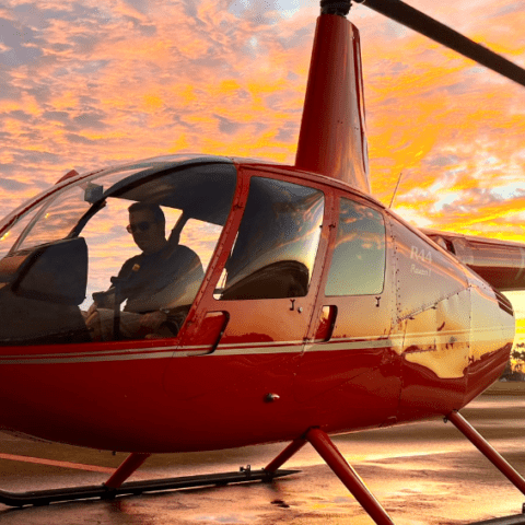 Magic Air Tours helicopter parked at Miami Executive Airport at sunset, ready for a scenic tour