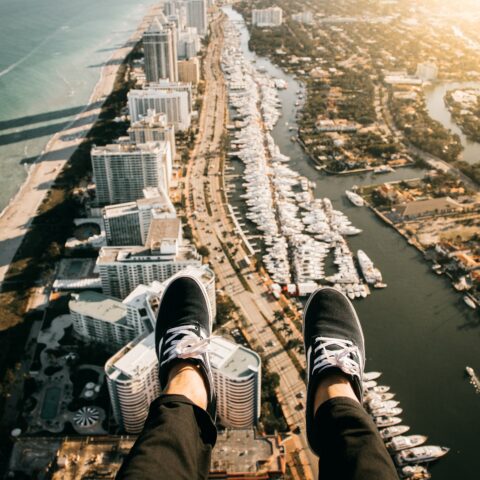 Customer enjoying a thrilling doors-off helicopter ride over Miami’s South Beach and skyline.